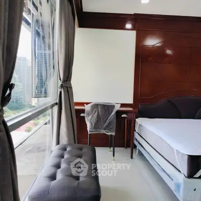 Modern bedroom with city view, featuring elegant wooden paneling and large windows for natural light.