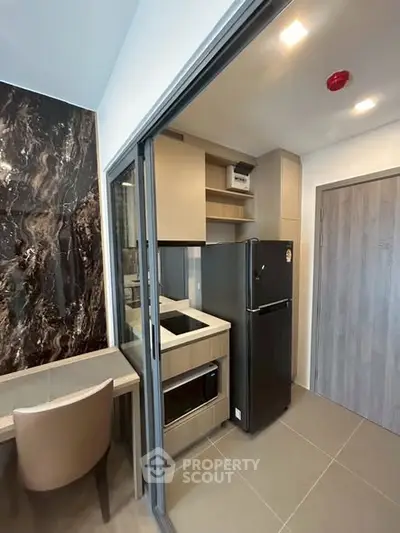 Modern compact kitchen with sleek appliances and stylish design