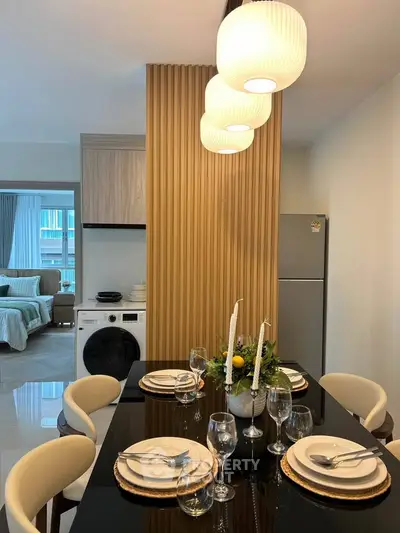 Modern dining area with elegant table setting and view into cozy living room
