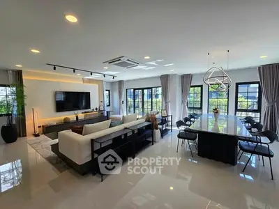 Luxurious open-plan living and dining area with modern decor and ample natural light.