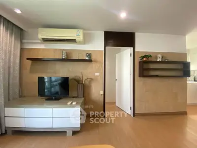 Modern living room with sleek TV unit and air conditioning, featuring stylish wooden shelves and neutral decor.