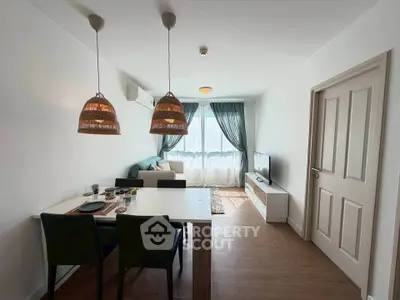 Modern living room with stylish decor, featuring a cozy seating area and dining space, perfect for relaxation.