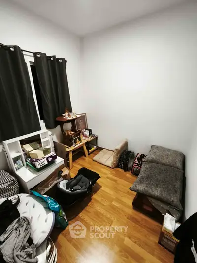 Cozy small bedroom with wooden flooring and minimalistic decor