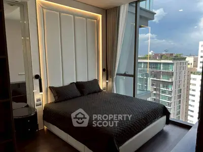 Luxurious bedroom with floor-to-ceiling windows offering stunning city views