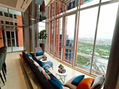 Luxurious high-rise living room with panoramic city views and elegant decor.