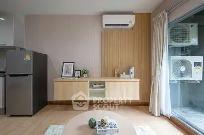 Modern living room with stylish decor and air conditioning, featuring a sleek wooden cabinet and large window.