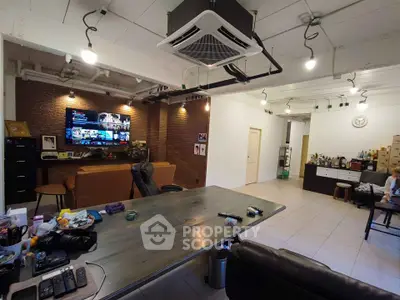 Spacious modern living room with industrial design and entertainment setup