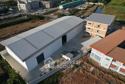 Aerial view of industrial warehouse complex with spacious outdoor area and modern facilities.