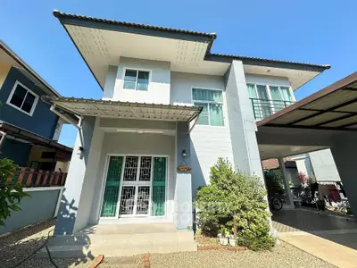 Modern two-story house with sleek design and spacious driveway in a sunny neighborhood.