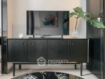 Modern living room with sleek black TV stand and stylish decor
