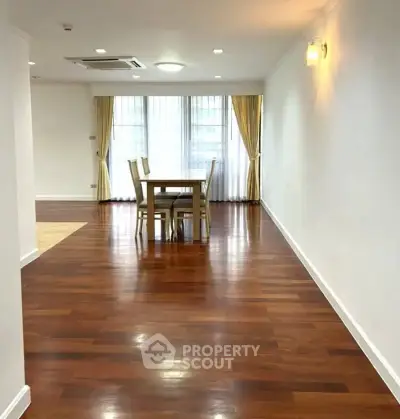 Spacious dining area with elegant wooden flooring and natural light