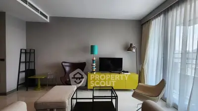 Modern living room with stylish furniture and large windows offering natural light.