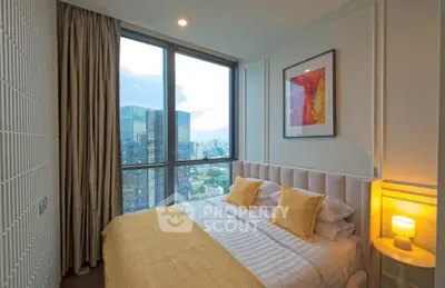 Luxurious bedroom with stunning city view and modern decor in high-rise apartment.
