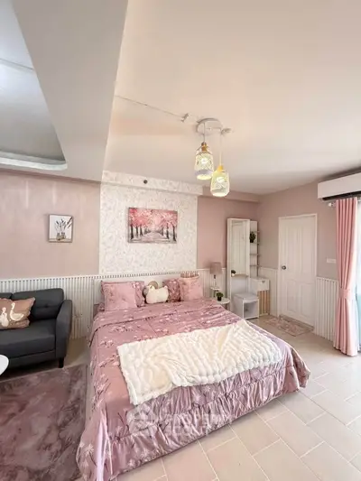 Charming bedroom with elegant decor and cozy ambiance, featuring a plush bed and stylish lighting.