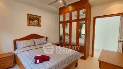 Cozy bedroom with mirrored wardrobe and elegant decor