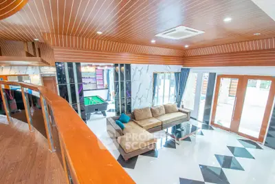 Luxurious living room with modern design, featuring a spacious sectional sofa and stylish ceiling.