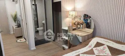 Cozy bedroom with elegant vanity and modern bathroom access, perfect for stylish living.