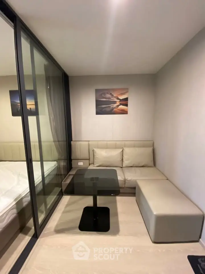 Modern compact living room with glass partition and stylish decor