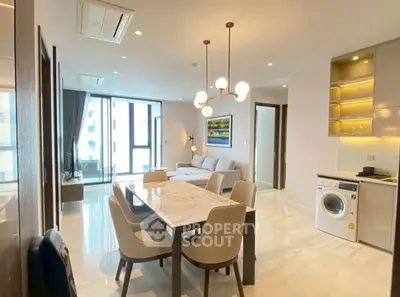 Modern open-plan living and dining area with elegant furnishings and natural light.
