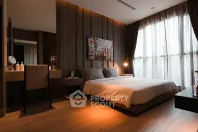 Luxurious modern bedroom with elegant decor and large window for natural light.