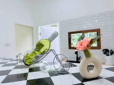 Stylish kitchen with modern decor and wine bottle display on checkered countertop.