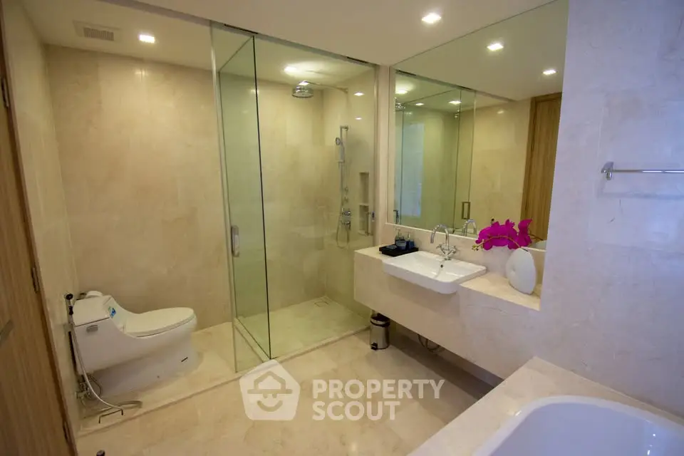 Luxurious modern bathroom with glass shower and elegant fixtures