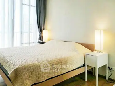 Bright and cozy bedroom with modern decor and large windows in a stylish apartment.