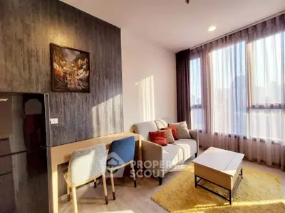 Bright and modern living room with stylish decor and large windows offering city views.