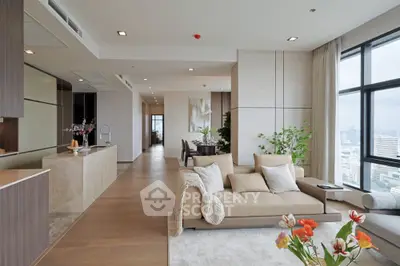 Luxurious open-plan living room with modern kitchen and stunning city view