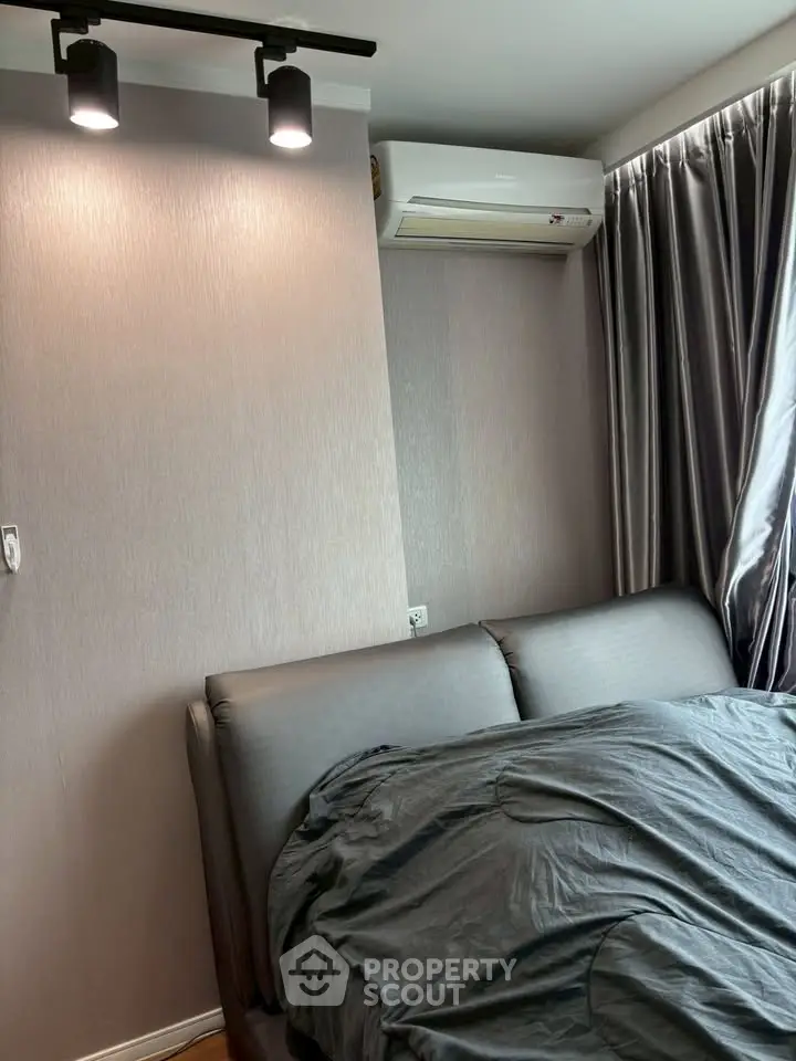Modern bedroom with sleek design featuring air conditioning and stylish lighting.