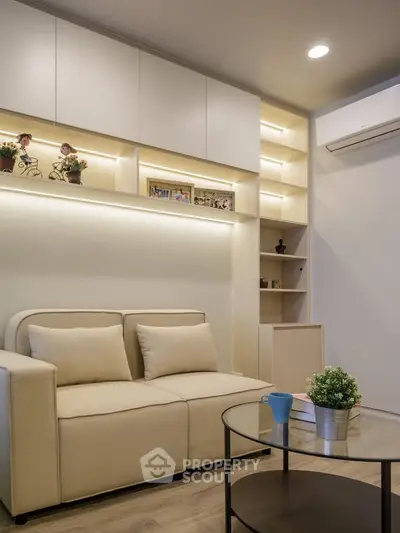 Modern living room with beige sofa, built-in shelves, and ambient lighting
