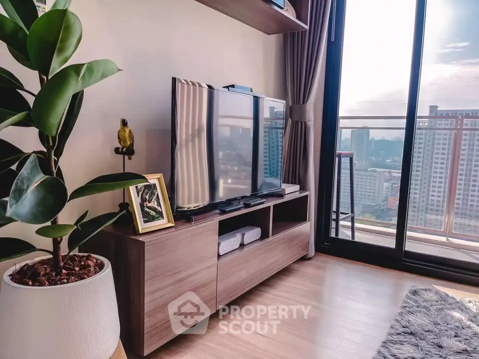 Modern living room with city view, stylish decor, and large balcony access.