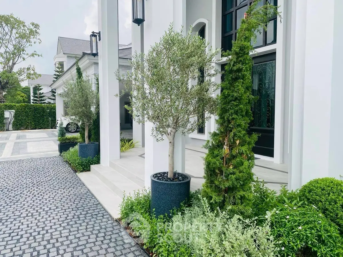 Elegant modern home exterior with lush greenery and stylish entrance