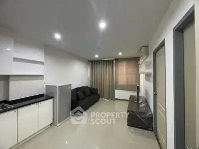 Modern living room with sleek furniture and open kitchen layout