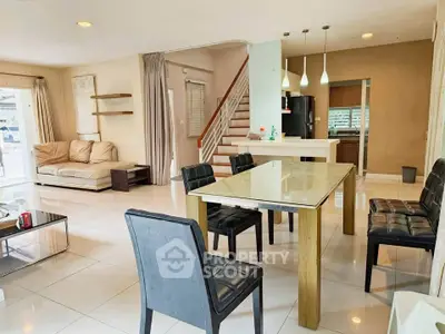 Spacious open-plan living and dining area with modern furnishings and natural light.