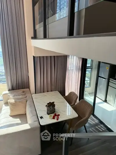 Modern duplex apartment with stylish dining area and large windows