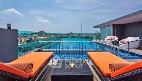 Luxurious rooftop pool with stunning city views and modern lounge chairs.