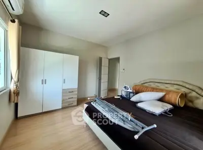 Spacious bedroom with modern furniture and natural light