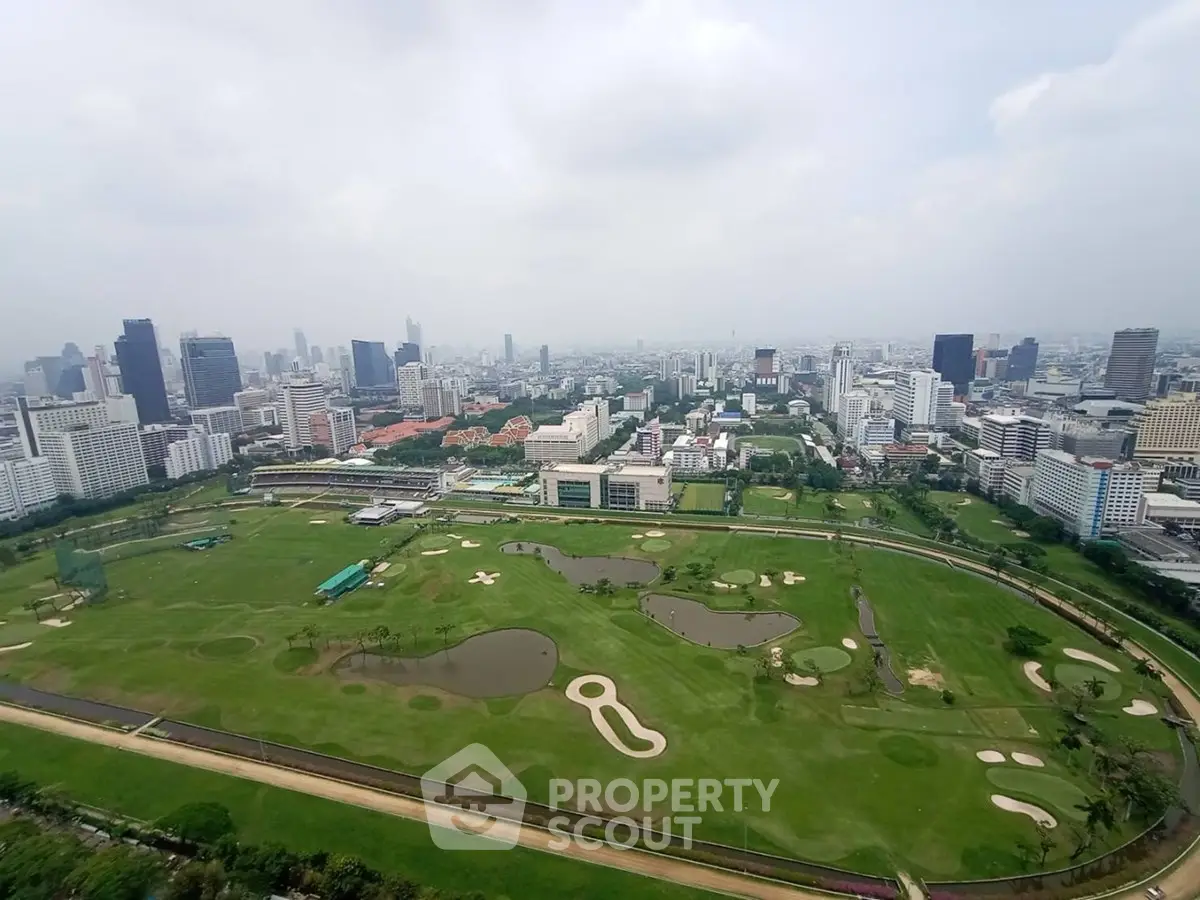Stunning aerial view of a sprawling golf course amidst a vibrant cityscape, perfect for luxury real estate development.