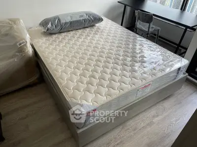 Modern bedroom with new mattress and sleek desk, perfect for urban living.