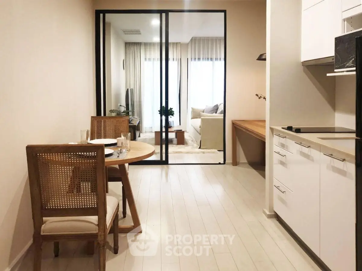 Modern open-plan kitchen and dining area with stylish furniture and natural light.