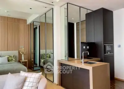 Modern open-layout kitchen with sleek cabinetry and cozy bedroom view