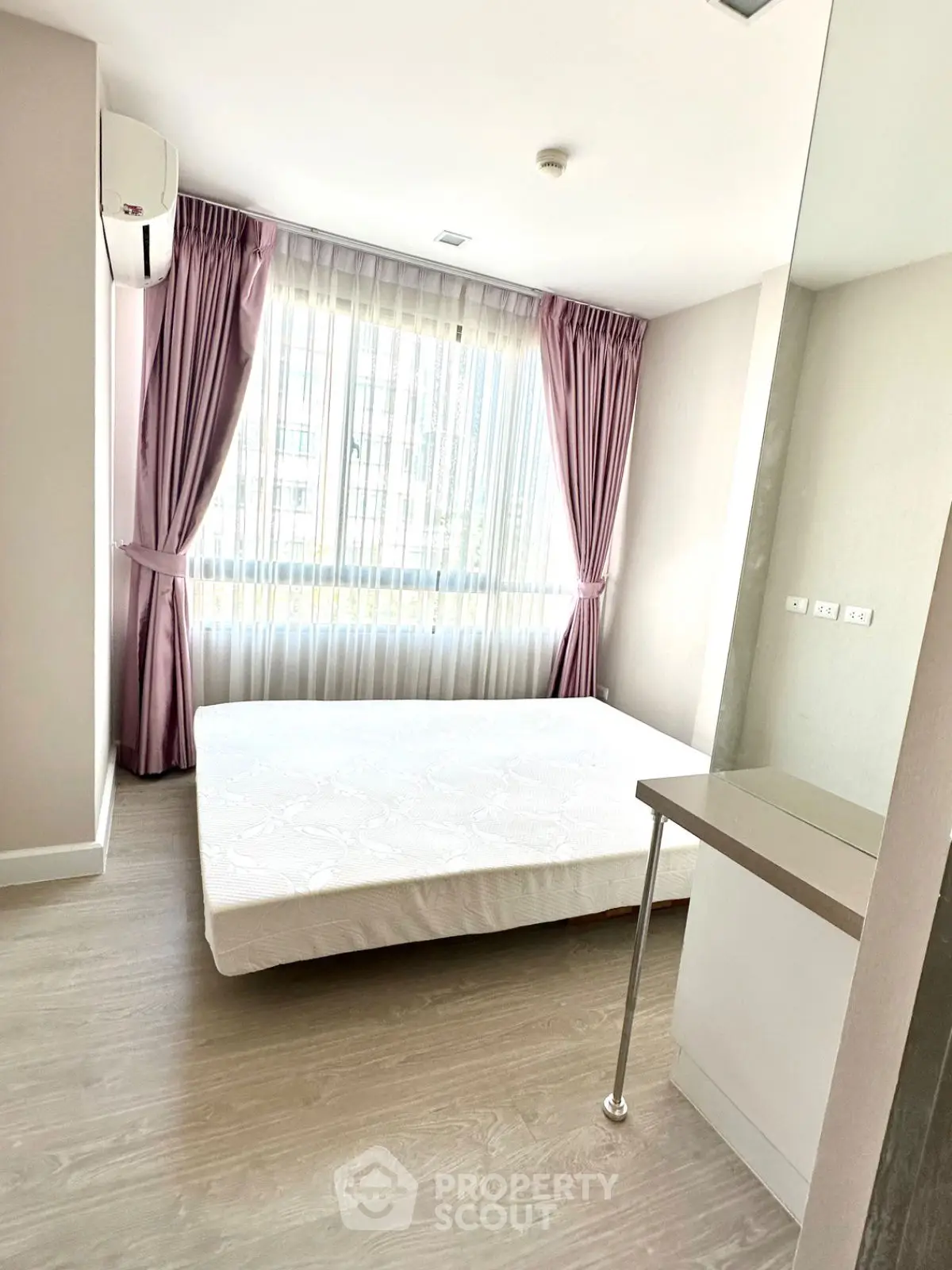 Bright bedroom with large window and modern decor