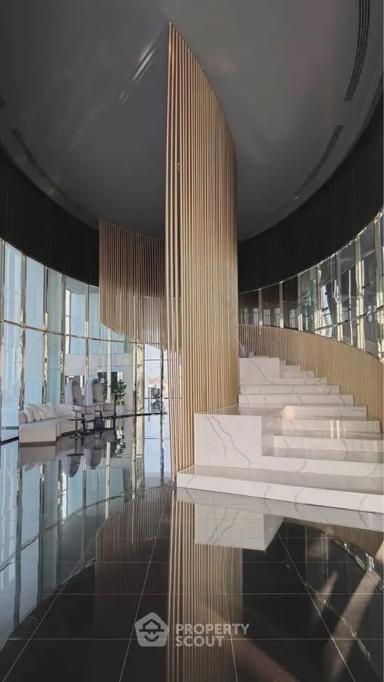 Luxurious modern building entrance with elegant staircase and sleek design.