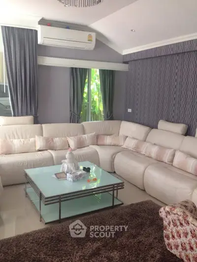 Luxurious living room with plush white sectional sofa and elegant decor