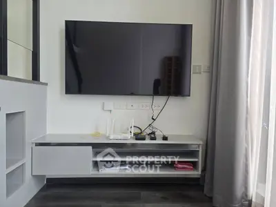 Modern living room with wall-mounted TV and sleek entertainment unit