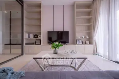 Modern living room with stylish decor and large windows for natural light.