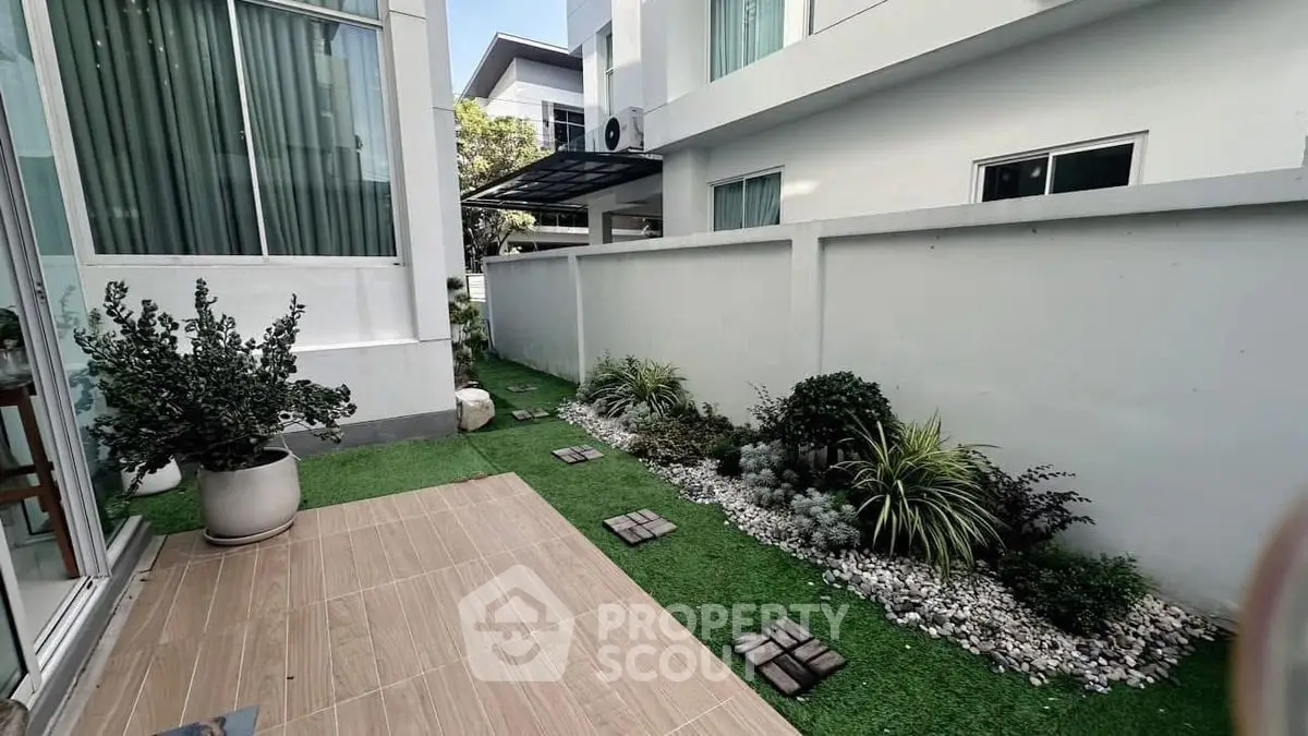 Charming townhouse garden with modern landscaping and cozy outdoor space.