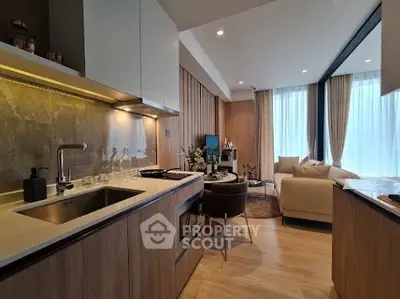 Modern open-layout kitchen and living room with elegant decor and natural light