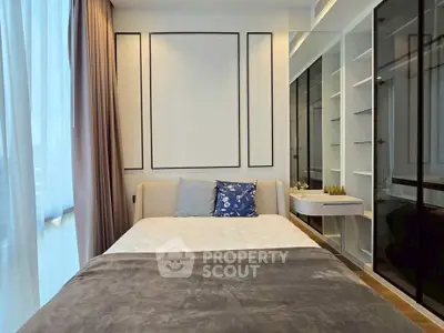 Modern bedroom with elegant decor and large windows for natural light.